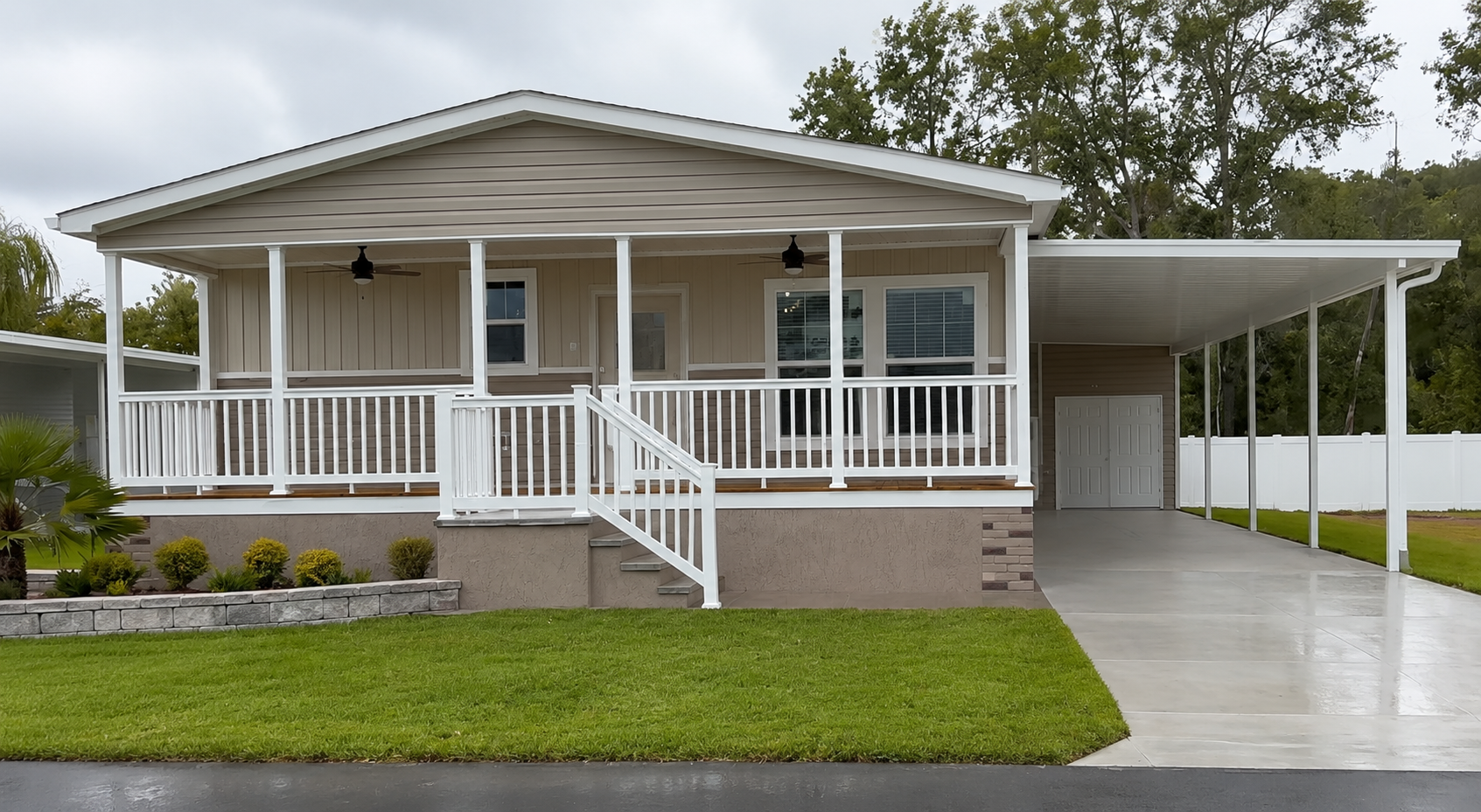 Finished manufactured home with driveway, porch, and carport